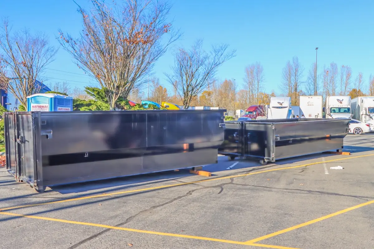 Professional dumpster rental service with roll-off container on residential driveway in Hurricane